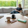 Load image into Gallery viewer, A Wayne Raven milk chocolate bar placed on the kitchen counter top