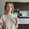 Load image into Gallery viewer, A girl holding a Carvetti collection dark milk chocolate bar in the kitchen
