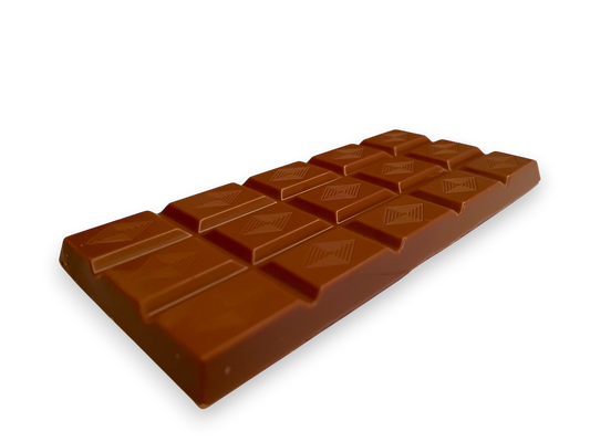 Close view of a darker milk chocolate bar with diamond shaped patterns on top